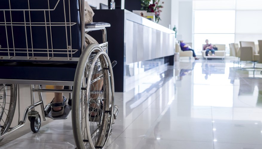 A close-up of a disabled person in a hospital corridor.