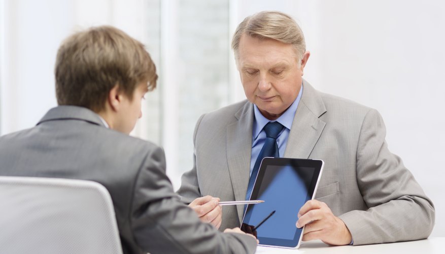 older man and young man with tablet pc