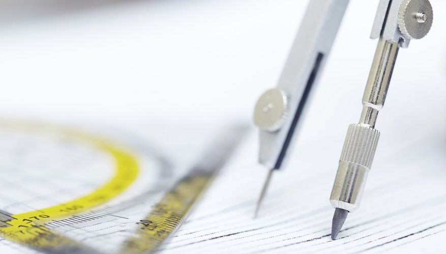 Photo Credit: Zhenikeyev/iStock/Getty Images A compass and protractor on papers.