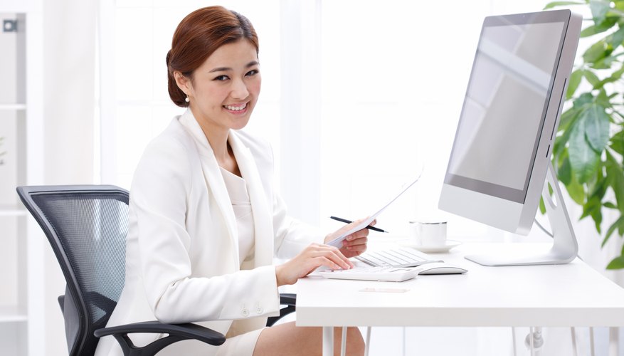 Young business lady sitting in front of computer