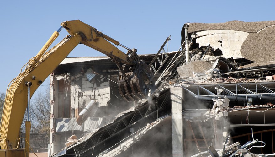 Photo Credit: Aneese/iStock/Getty Images An excavator destroys a building.