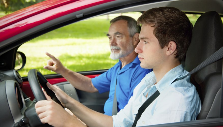 Teen in a car getting driving instructions from a teacher. Teen in a car getting driving instructions from a teacher.