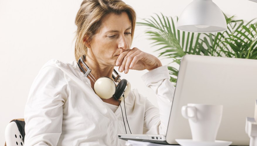 Beautiful mature business woman working with laptop on desk.