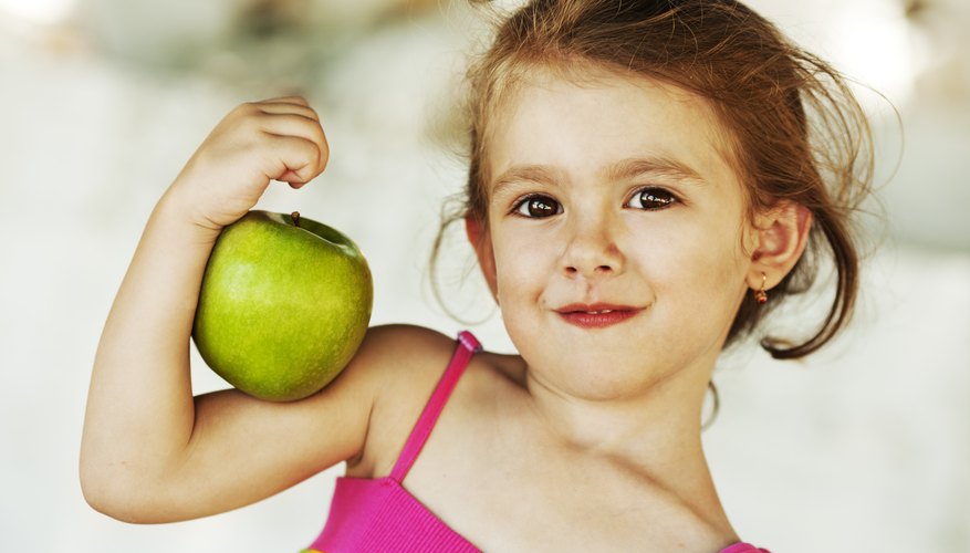 Child holding apple Child holding apple