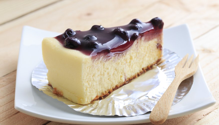 A slice of blueberry cheesecake on a wooden table. A slice of blueberry cheesecake on a wooden table.