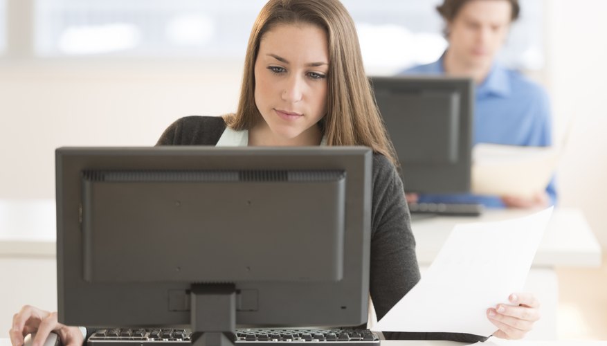 Businesswoman Using Desktop PC At Desk