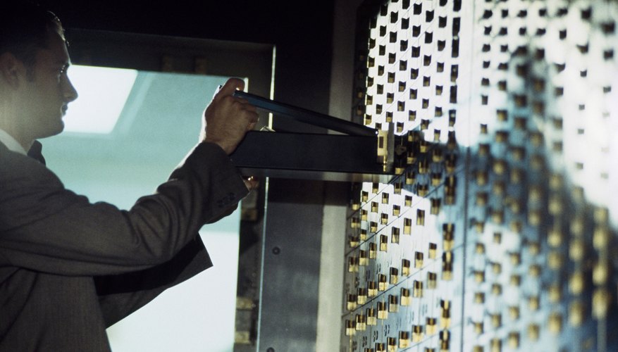 portrait of businessman opening safe