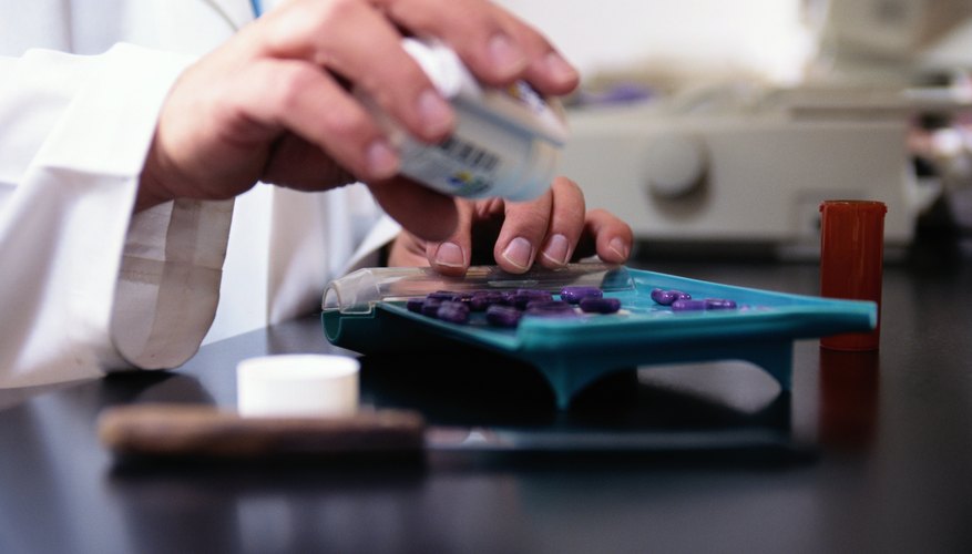 Pharmacist sorting pills Pharmacist sorting pills