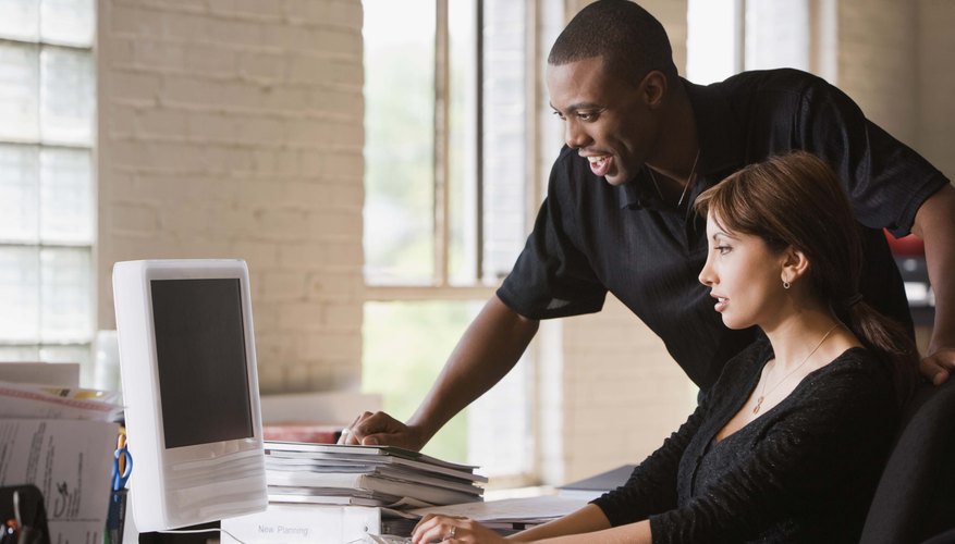 Businesspeople working at desktop computer