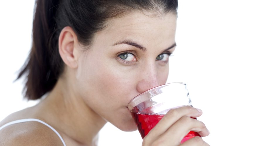 Woman drinking cranberry juice Woman drinking cranberry juice