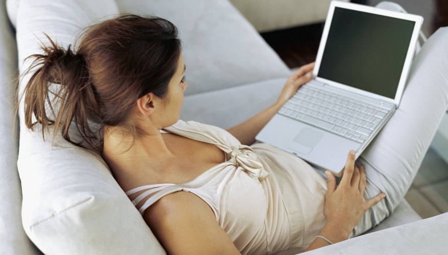 high angle view of a businesswoman sitting on couch and using a laptop