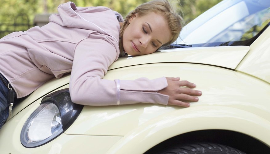 Woman hugging new car