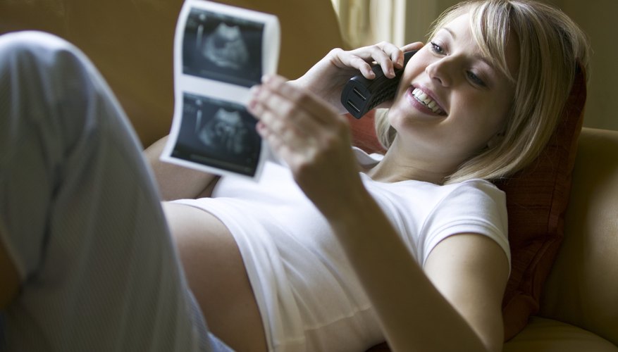 Woman looking at ultrasound photos Woman looking at ultrasound photos
