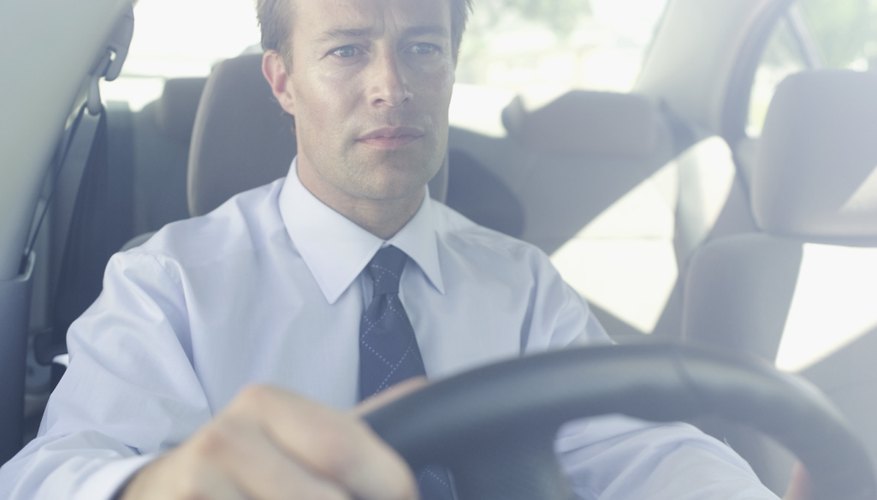 front view of a man driving a car