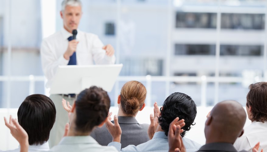 Photo Credit: Wavebreakmedia Ltd/Wavebreak Media/Getty Images Man presenting in meeting