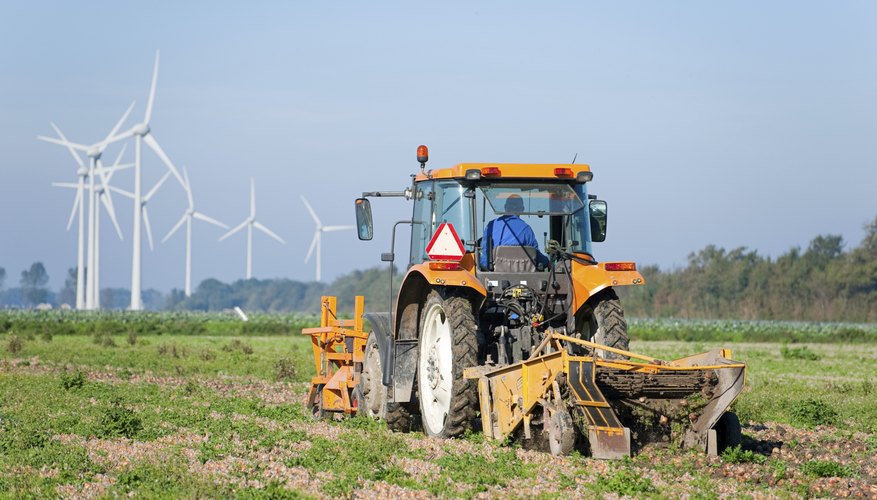 Photo Credit: Allard Schager/iStock/Getty Images A farmer drives a tractor over a field.