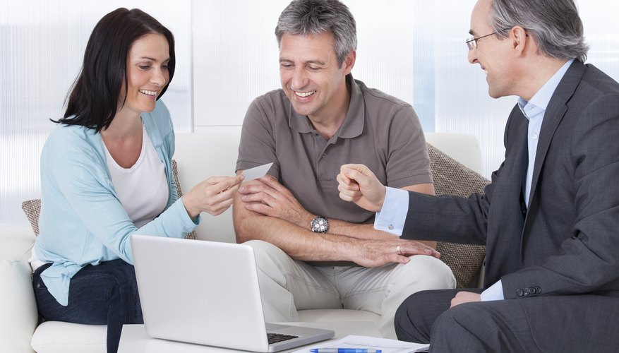 Consultant Offering Business Card To Couple
