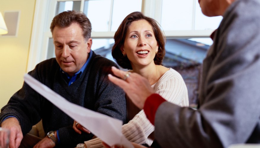 Photo Credit: Ryan McVay/Digital Vision/Getty Images Financial planner and couple