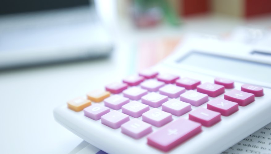 Calculator next to a laptop
