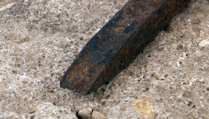 Photo Credit: Scott Sanders/iStock/Getty Images Score the surface of the geode with the chisel.