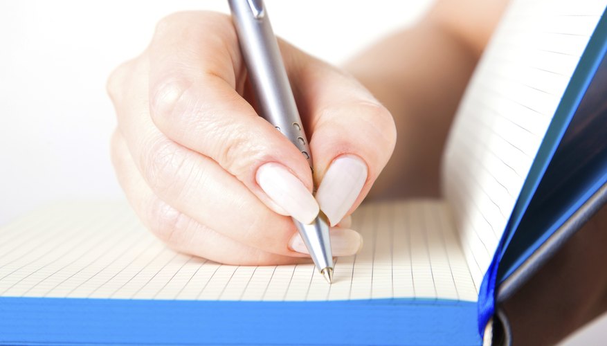 Female hand writing in a notebook