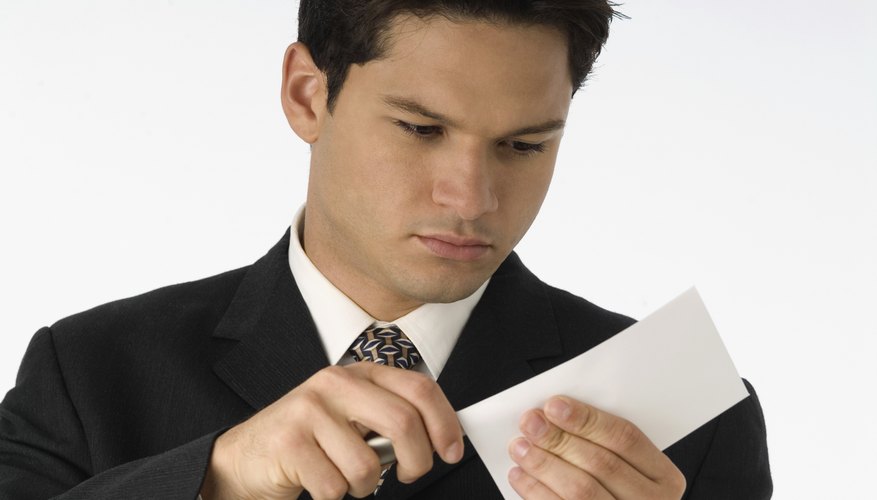 Businessman opening letter with letter opener, close-up