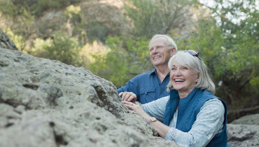 Smiling retired couple out on a hike.