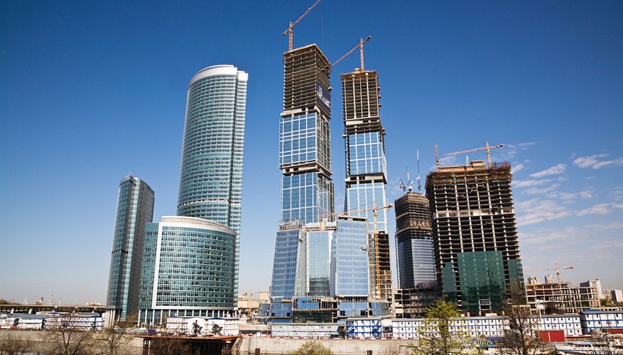 Photo Credit: Jupiterimages/Photos.com/Getty Images modern skyscrapers under construction
