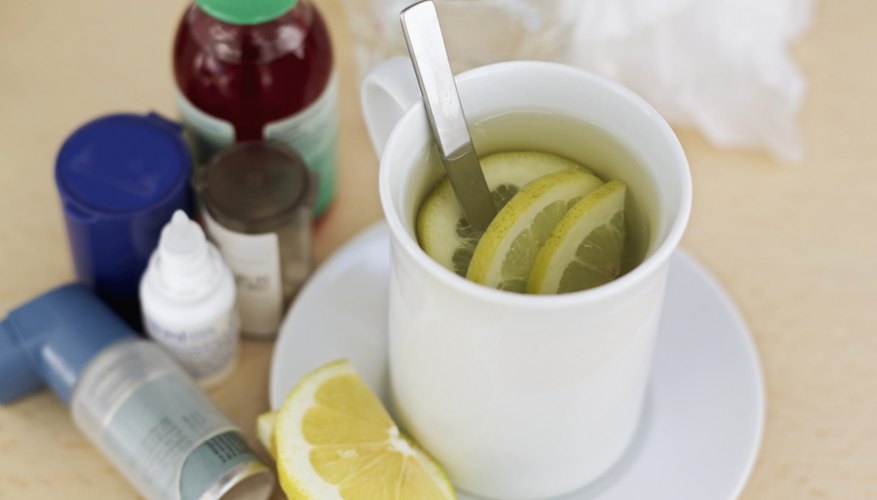 Cold medicine along with a cup tea and lemon. Cold medicine along with a cup tea and lemon.