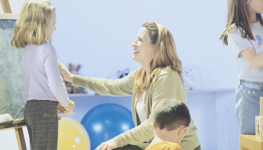 Woman talking with girl in classroom setting