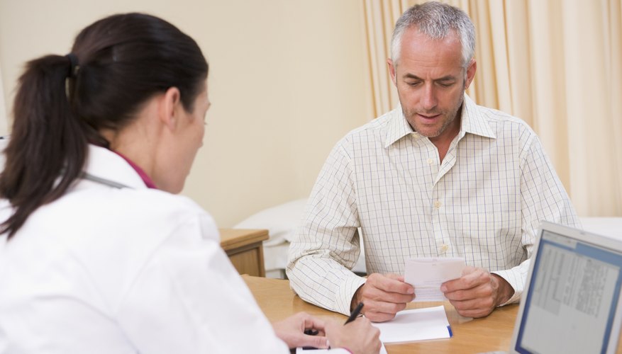 Doctor writing prescription for patient Doctor writing prescription for patient