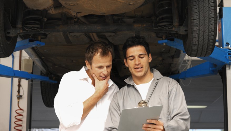 Front view of mechanic showing clip-board to customer