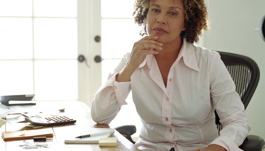 Mature woman in home office, portrait