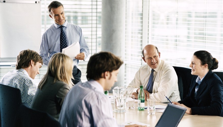Photo Credit: Digital Vision./Photodisc/Getty Images boss updating employees with status of company