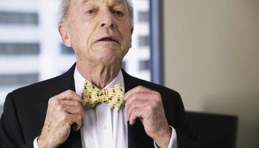 Senior businessman straightening his bowtie