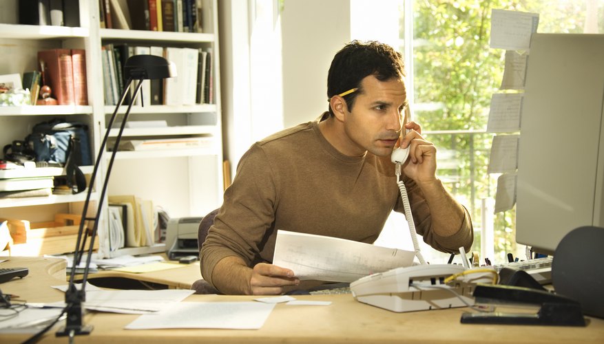 Man using telephone in home office