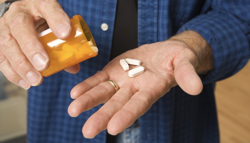 Man with prescription pills in his palm