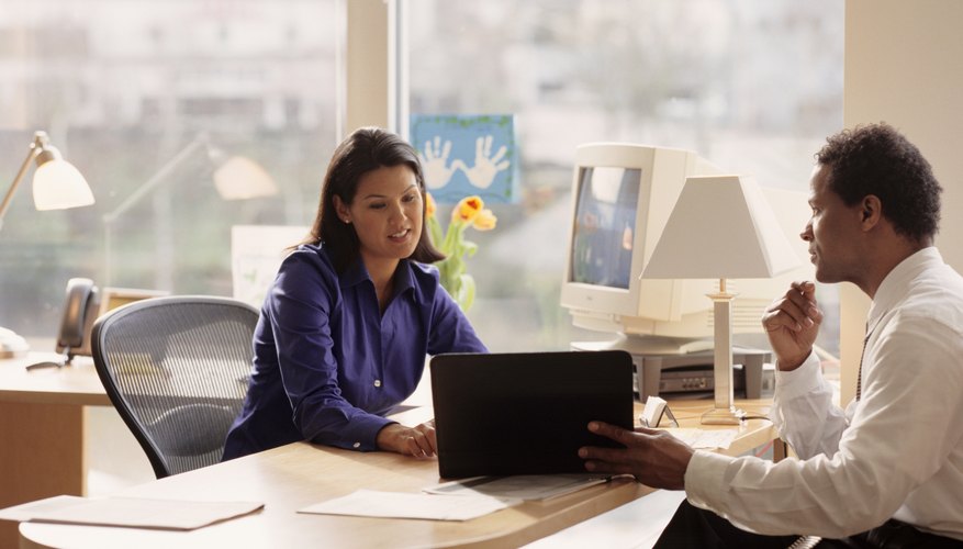 Man and woman talking in office
