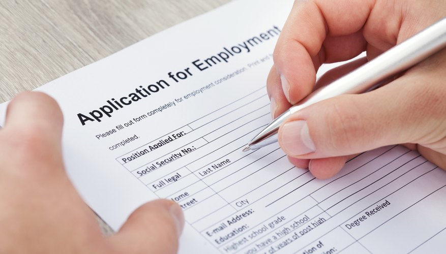 A man is filling out an application for employment.