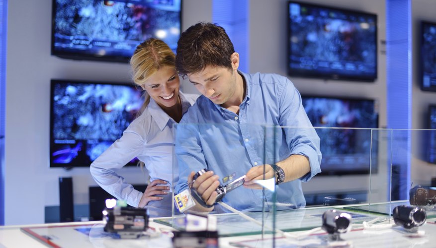 Photo Credit: .shock/iStock/Getty Images Couple in consumer electrics store buying a camera