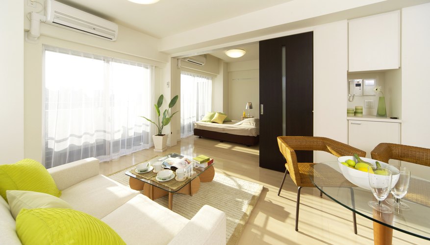 A white living room and dining area with lime green accents. A white living room and dining area with lime green accents.