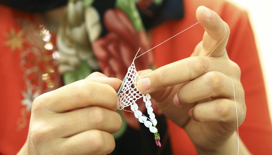 Photo Credit: MEHMET CAN/iStock/Getty Images Artist working on handmade jewelry