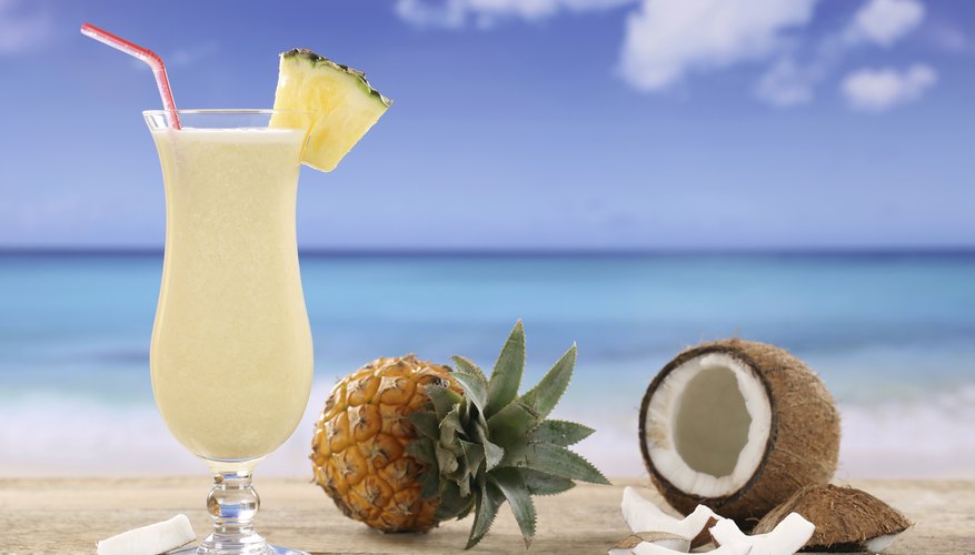 Photo Credit: Boarding1Now/iStock/Getty Images Coconut oil can dissolve in an aqueous pina colada because of the amphipathic nature of rum