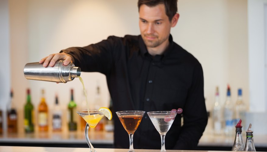 Photo Credit: Wavebreakmedia Ltd/Wavebreak Media/Getty Images A man is pouring drinks.