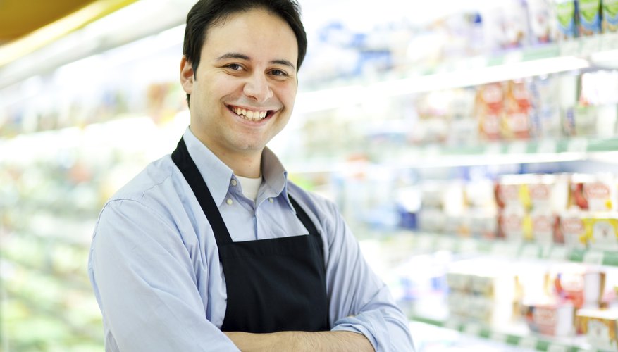 Smiling store keeper in his supermarket