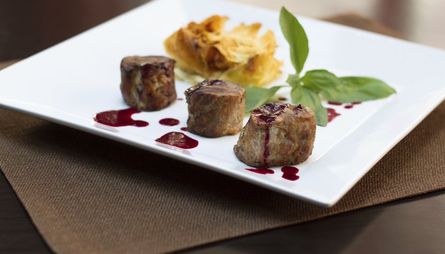 Photo Credit: kornyeyeva/iStock/Getty Images Steak cubes on a plate.