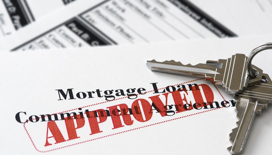 An approved mortgage loan application with keys to a house.