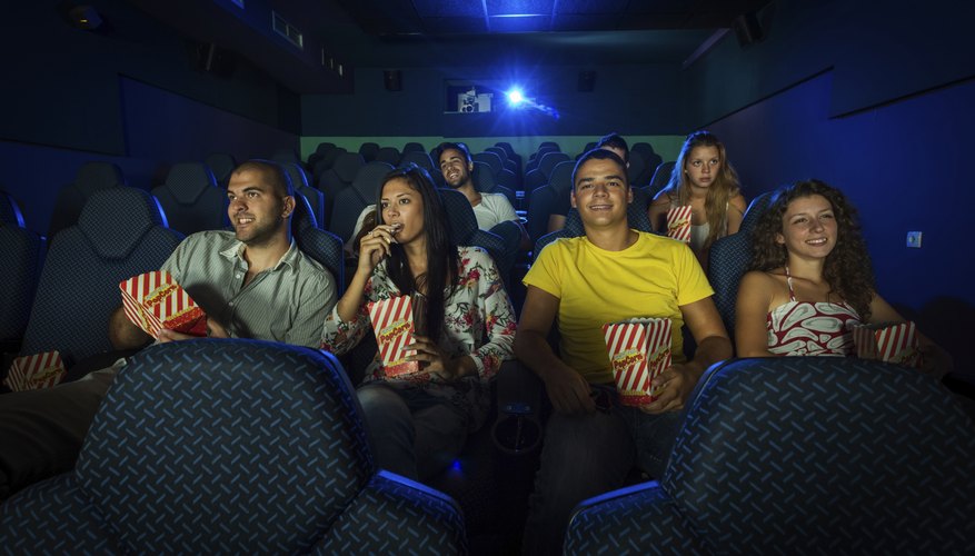 Photo Credit: Notorious91/iStock/Getty Images Theatre of people watching movie screen