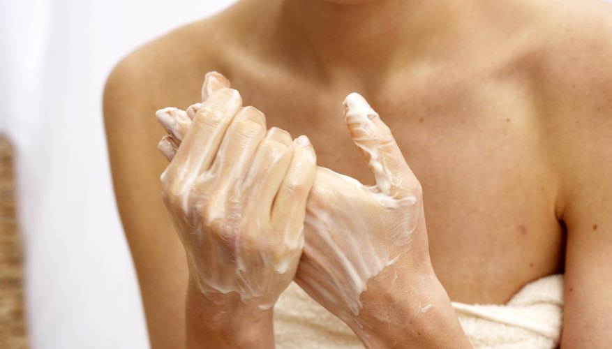 woman applying prescripton cream to hands woman applying prescripton cream to hands