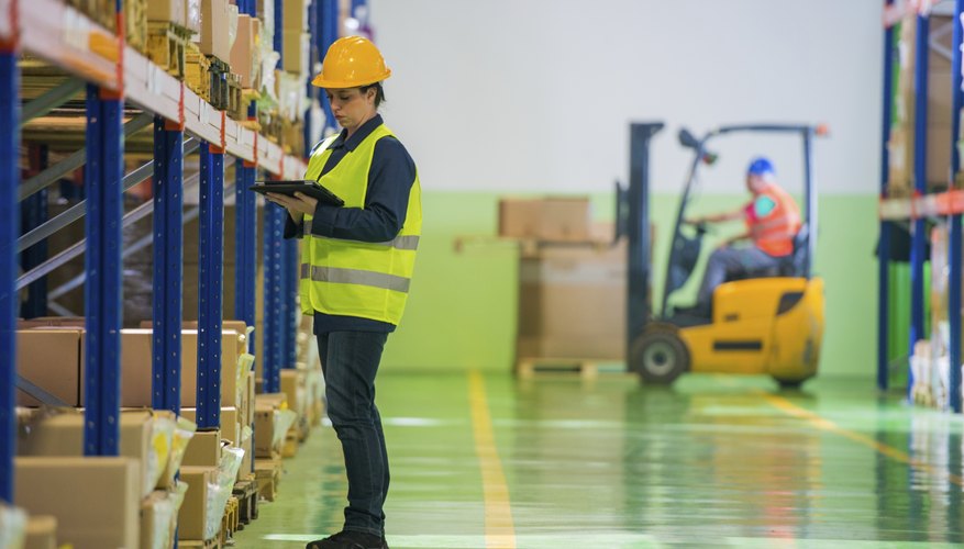 Female Warehouse Employee Doing A Checklist